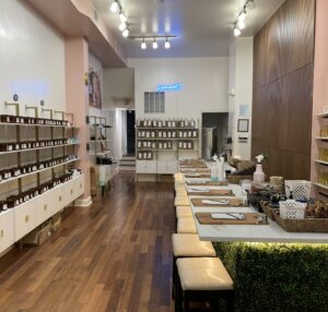 Baltimore studio front room containing a long counter with stools as well as shelves of candles